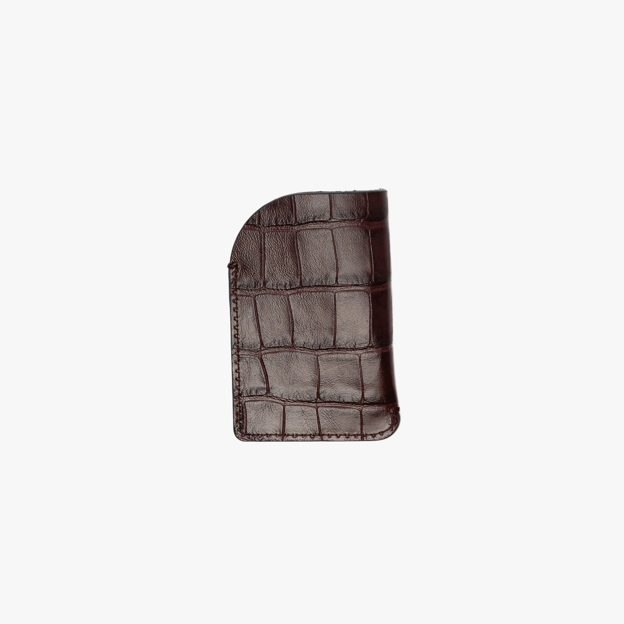Back panel of STOW London's Mini Cardholder in Burgundy Embossed Croc leather on a light grey background