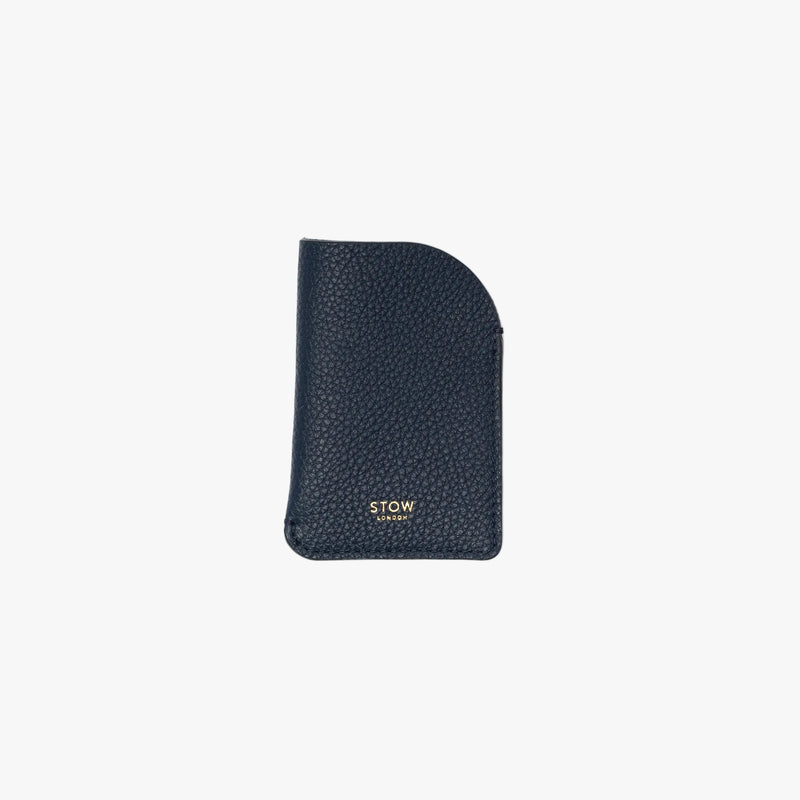 STOW London's Mini Cardholder in Navy pebbled leather on a light grey background featuring a small gold embossed logo on the front bottom