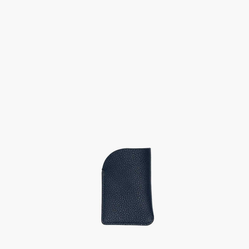 Back panel of STOW London's Mini Cardholder in Navy pebbled leather on a light grey background 