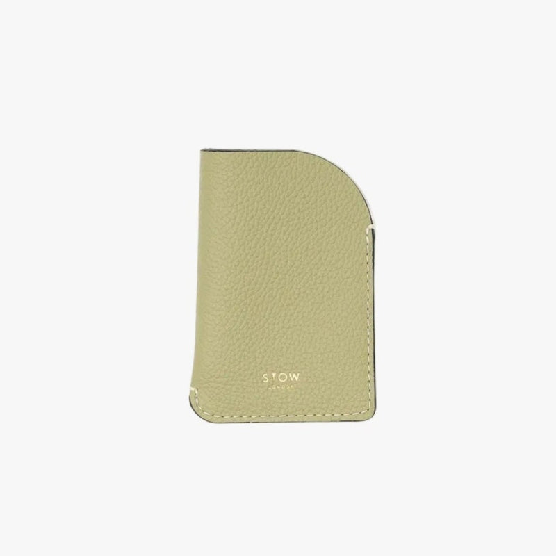 STOW London's Mini Cardholder in Pale Green pebbled leather on a light grey background featuring a small gold embossed logo on the front bottom
