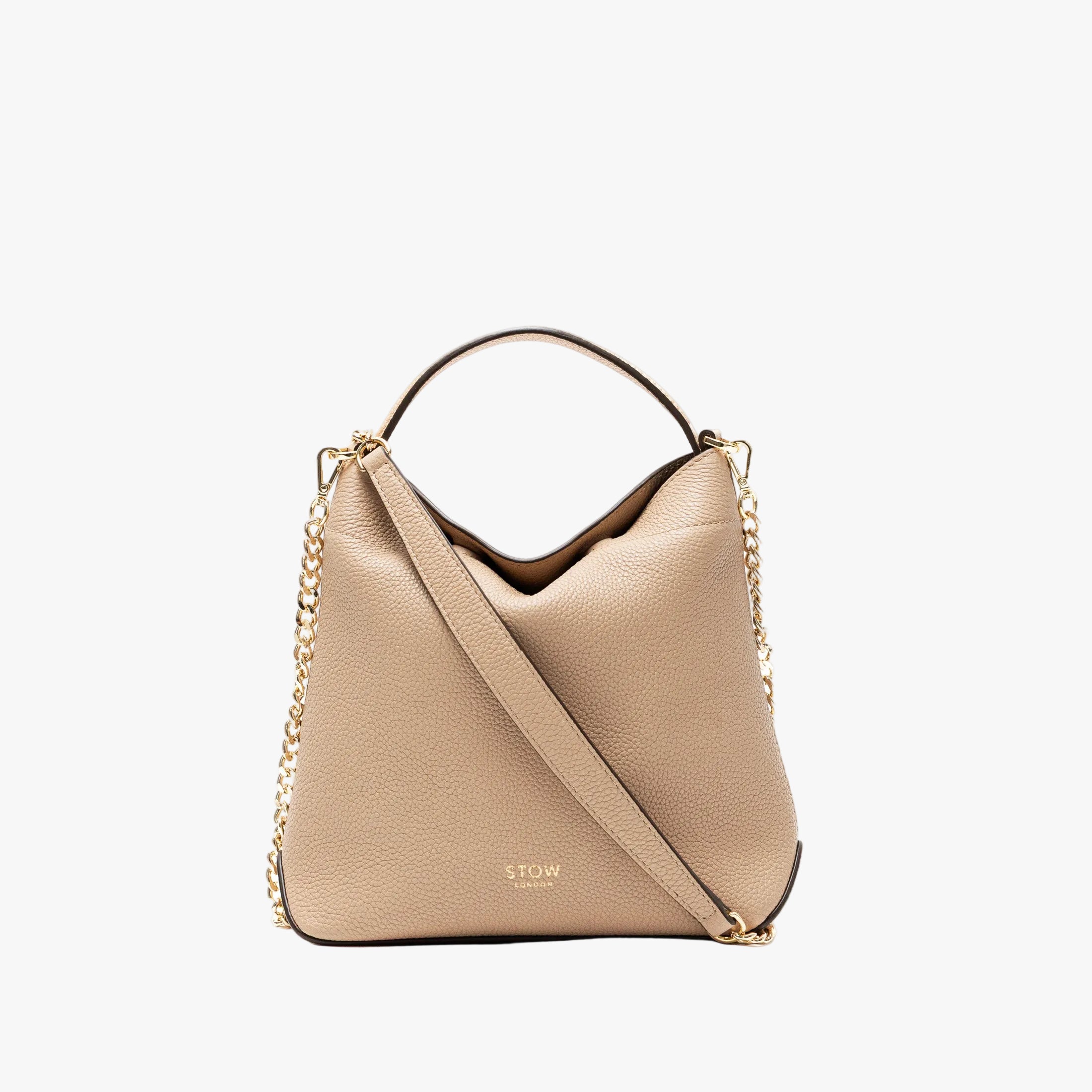 STOW London's Mini Curve in Camel pebbled leather and detachable gold chain crossbody strap on a light grey background 