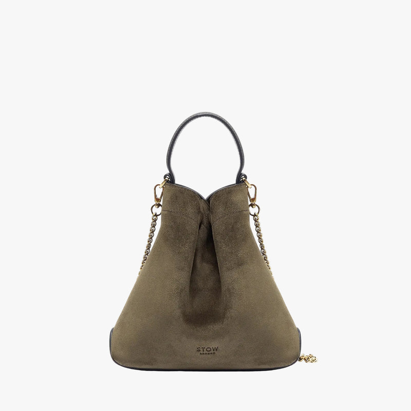 STOW London's Mini Curve in Dark Green suede leather featuring gold-coated stainless steel hardware on a light grey background 