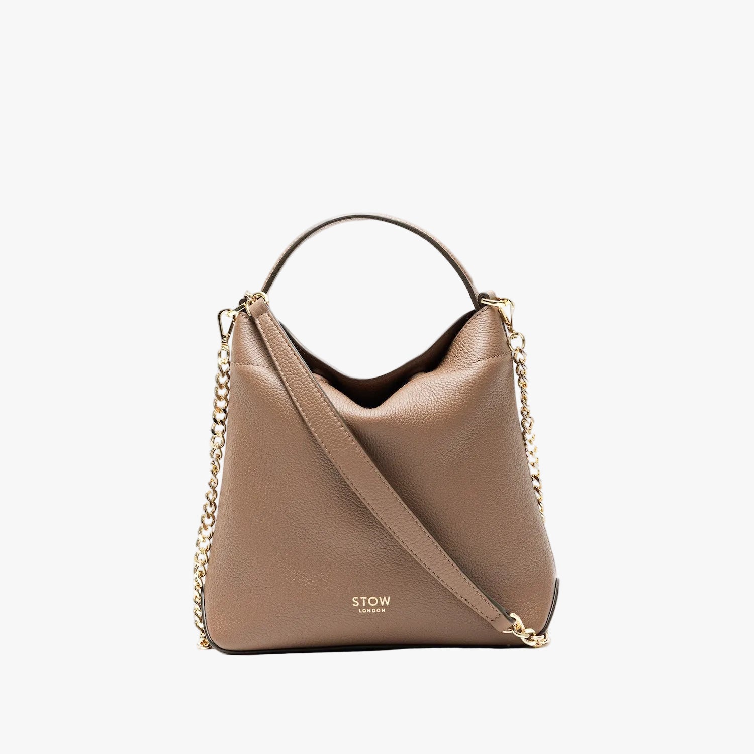 STOW London's Mini Curve in Mocha pebbled leather styled as a flap bag featuring gold-coated stainless steel hardware and chain strap on a light grey background