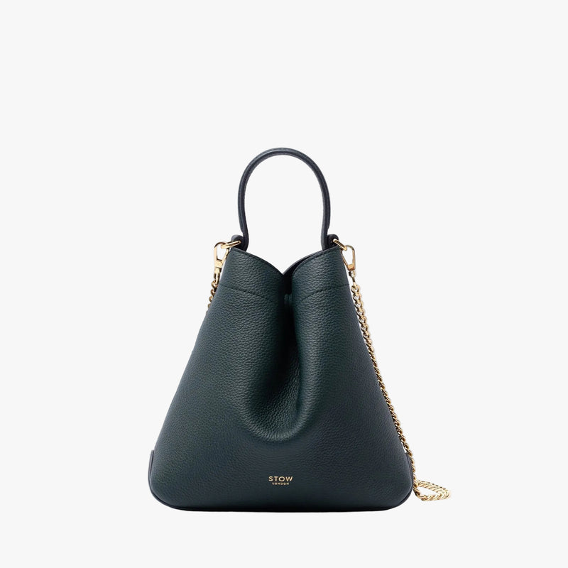 STOW London's Mini Curve in New Forest pebbled leather on a light grey background featuring the detachable gold plated chain strap