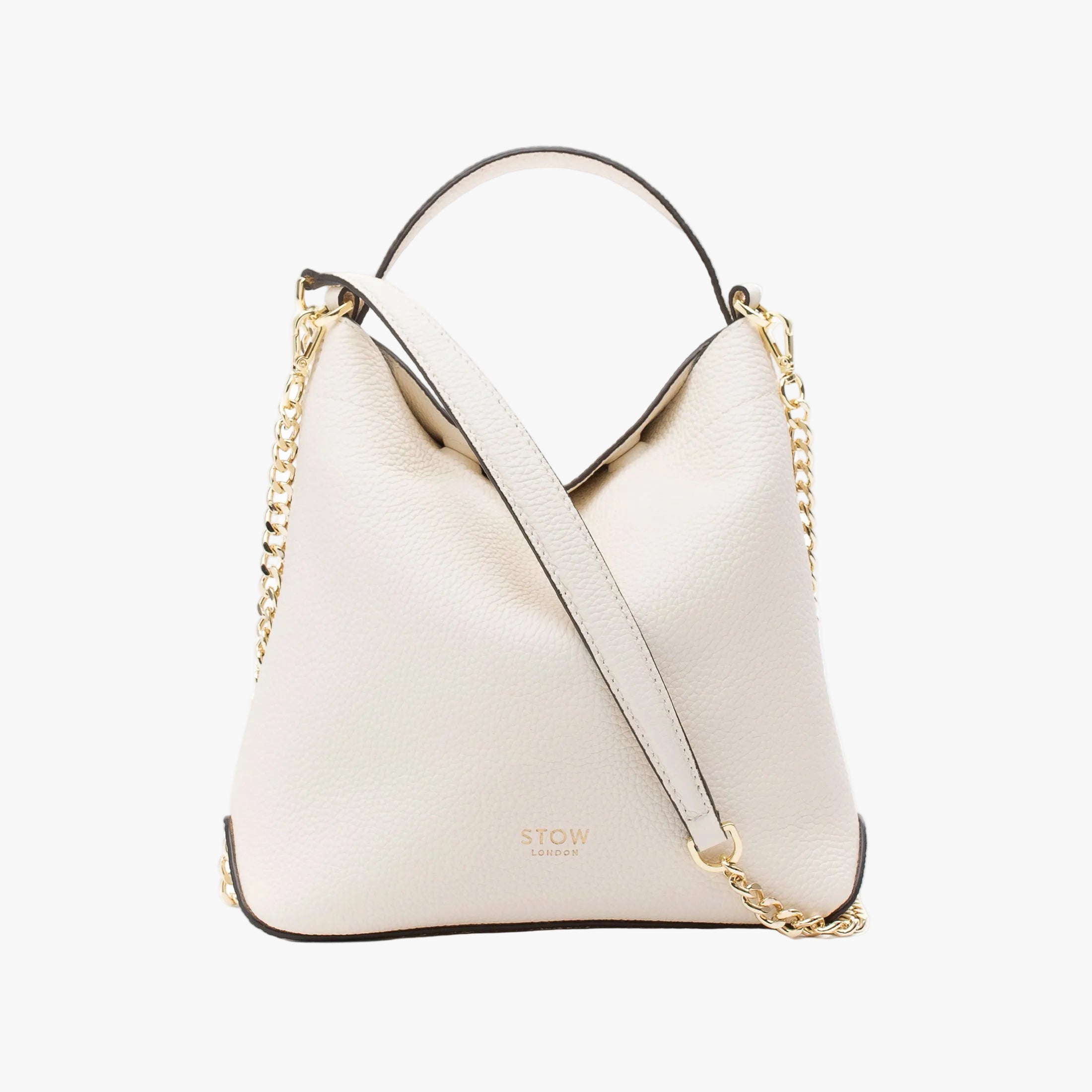 STOW London's Mini Curve in Spring Moon pebbled leather and detachable gold chain crossbody strap styled as a flap bag on a light grey background 