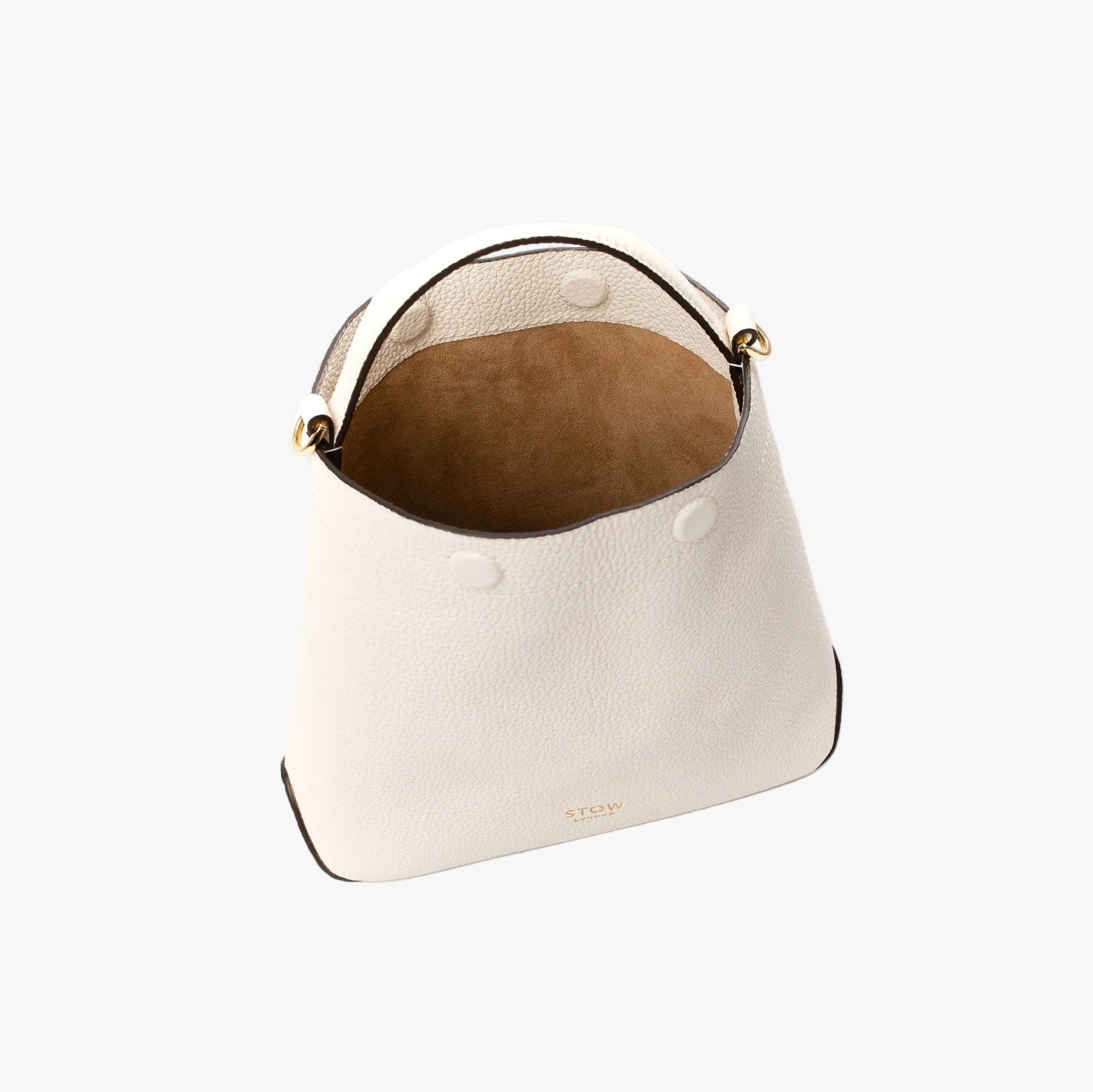 Top view of STOW London's Mini Curve in Spring Moon pebbled leather on a light grey background with magnets open showing suede interior lining