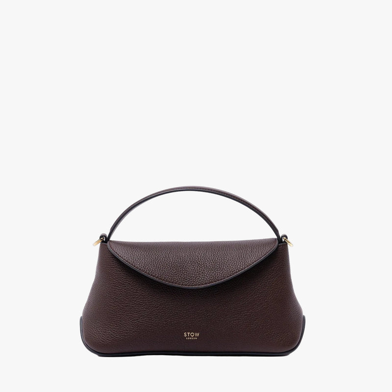 STOW London's Mini East West in Espresso pebbled leather on a light grey background featuring gold-coated stainless steel hardware 