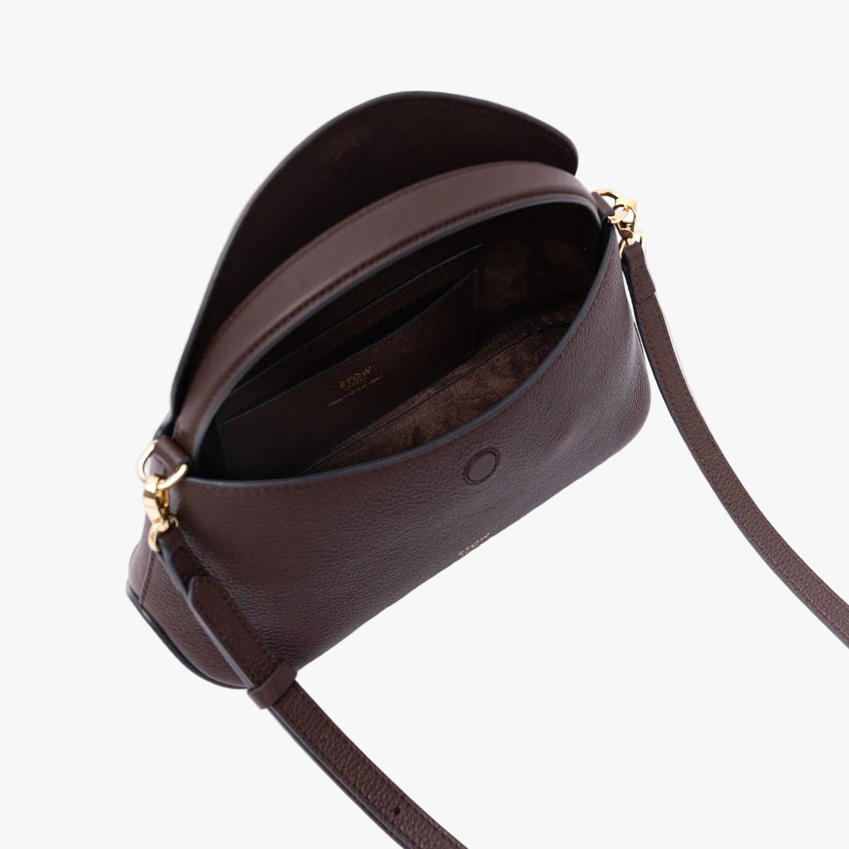 Top view of STOW London's Mini East West in Espresso pebbled leather on a light grey background with flap open showing the chocolate suede interior and leather slip pocket featuring gold-coated stainless steel hardware 