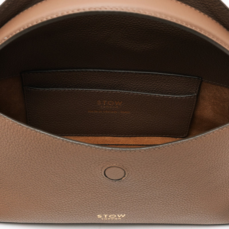 Close up of the interior of STOW London's Mini East West in Mocha pebbled leather featuring suede lining and leather slip pocket