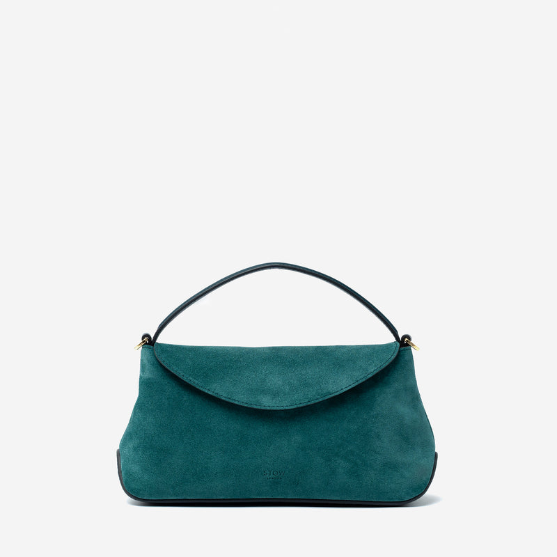 STOW London's Mini East West in Ocean Teal suede leather featuring gold-coated stainless steel hardware on a light grey background