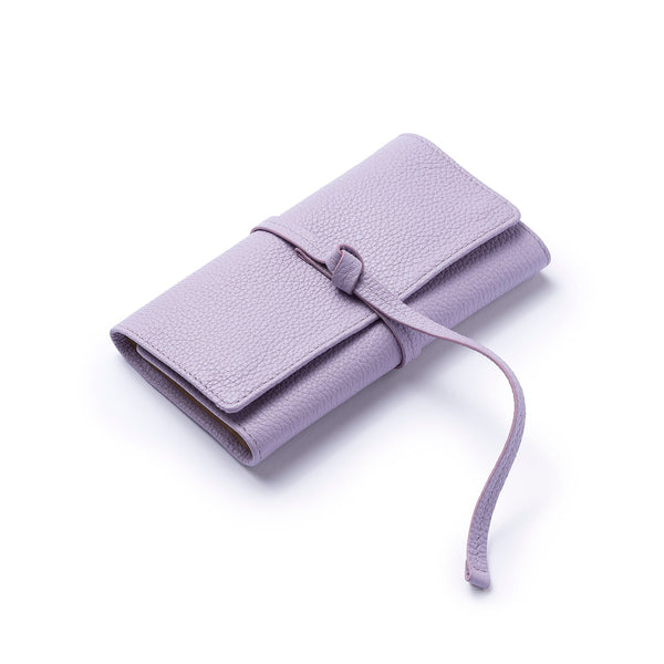 STOW Mini Jewellery Roll in Wild Lavender pebbled leather closed with leather tie.