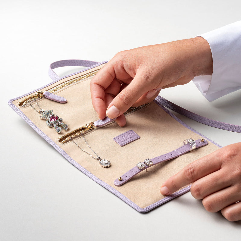 STOW London Mini Jewellery Roll in Wild Lavender leather, fully open showing zipped pockets and suede lining.