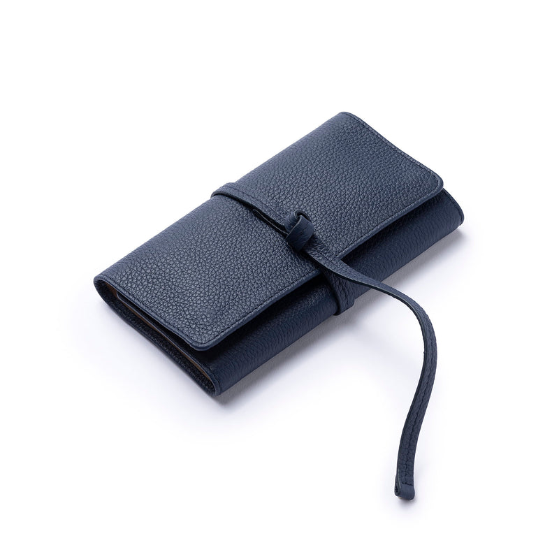 STOW Mini Jewellery Roll in Navy pebbled leather closed with leather tie.