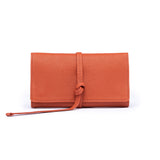 STOW Mini Jewellery Roll in Clay Orange pebbled leather.
