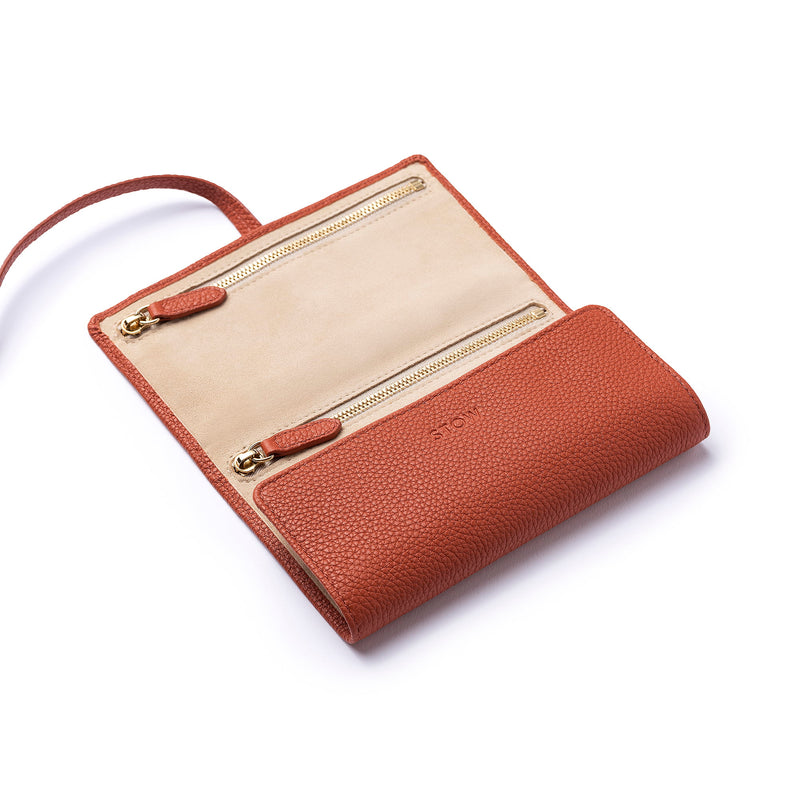 STOW Mini Jewellery Roll in Clay Orange colour, half open showing zipped pockets.