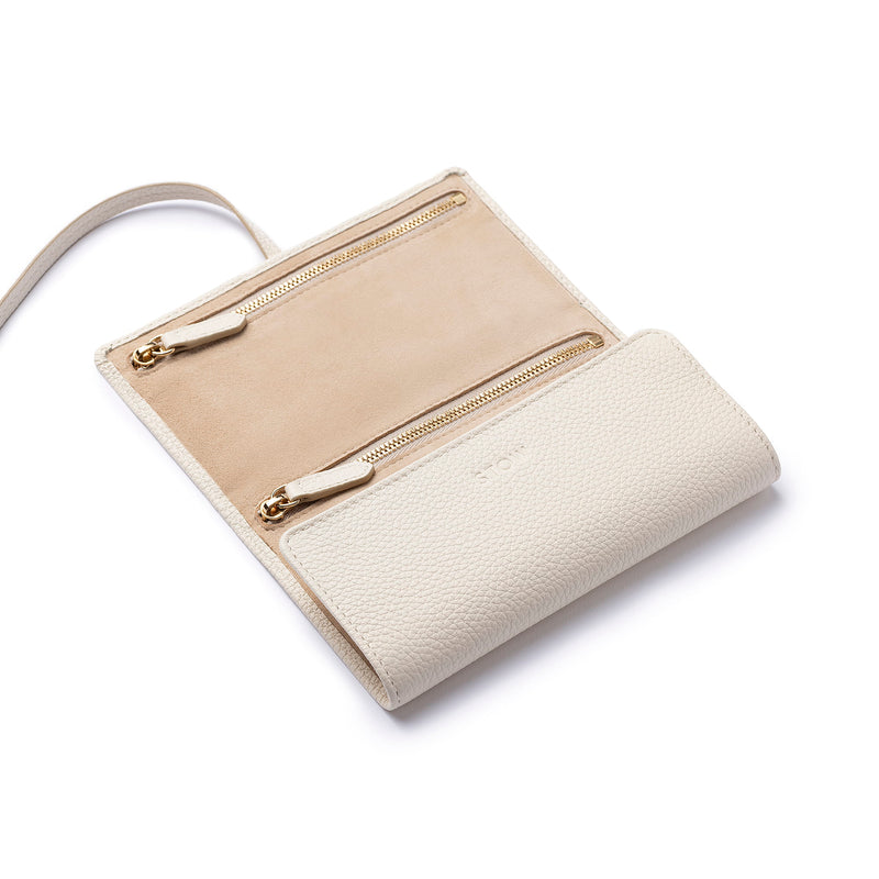 STOW London Mini Jewellery Roll in Spring Moon leather, half open showing zipped pockets and suede lining.