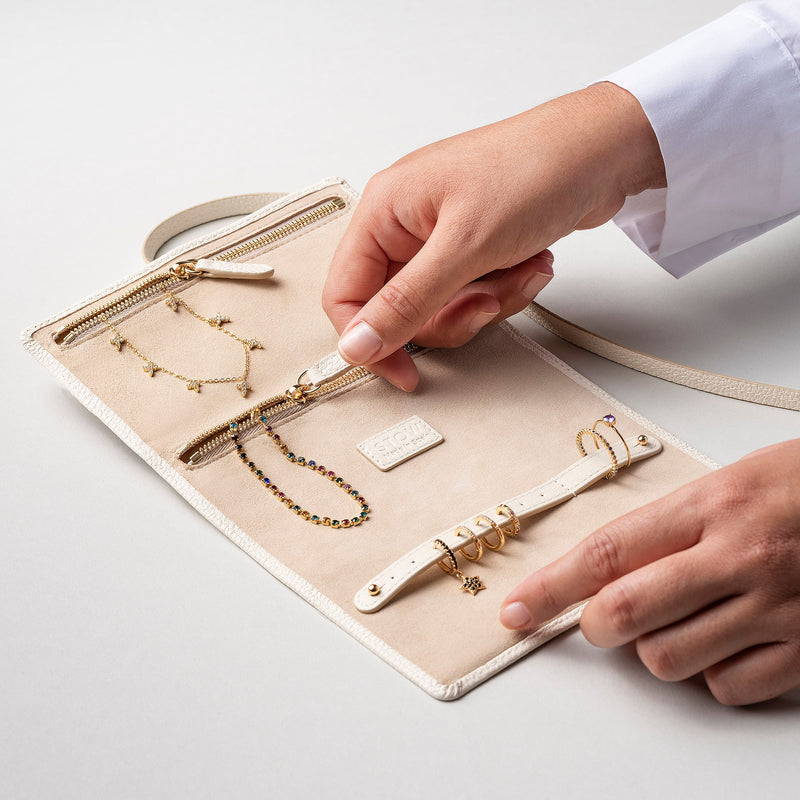 STOW London Mini Jewellery Roll in Spring Moon leather, fully open showing zipped pockets and suede lining.