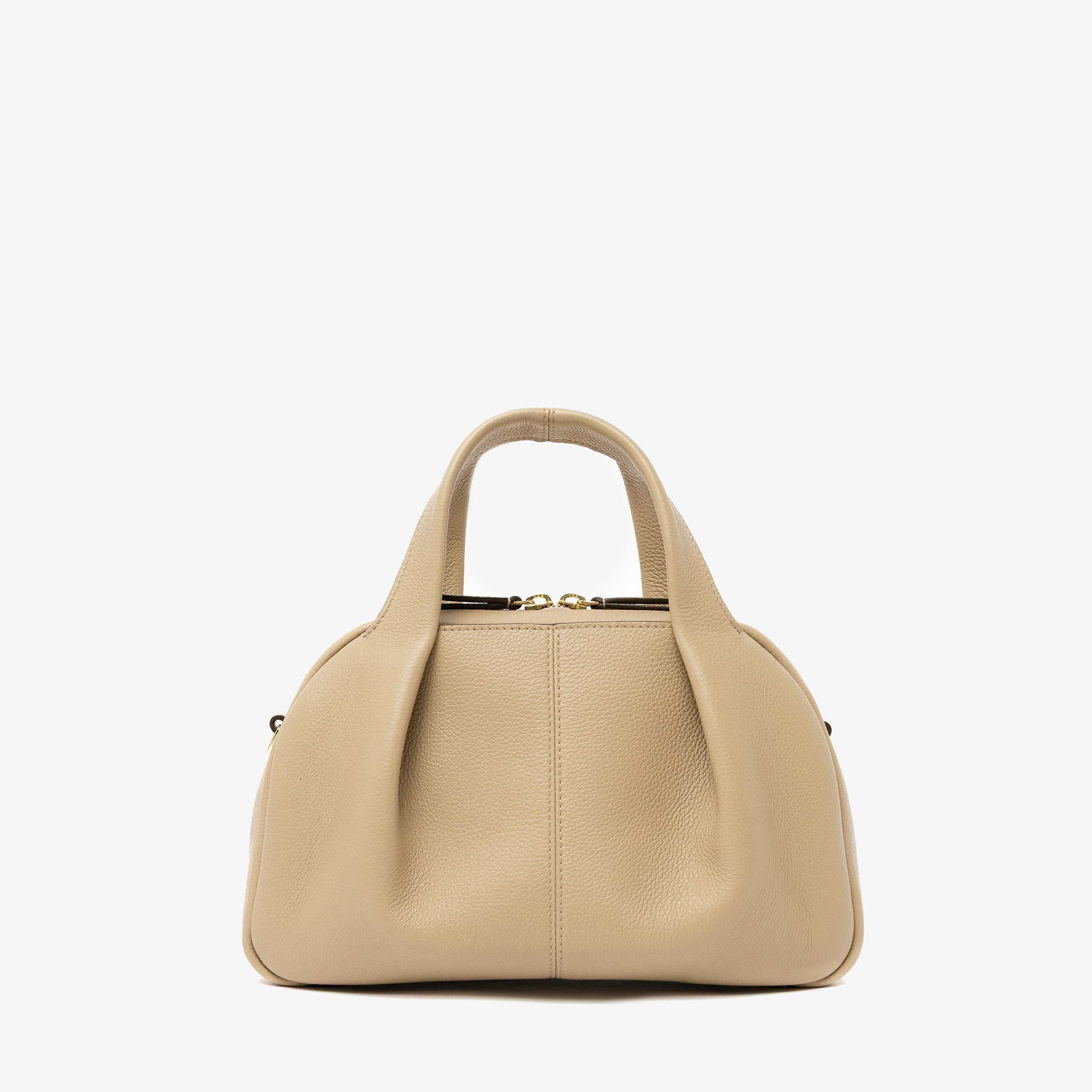 STOW London's Mini Bowling bag in Camel pebbled leather featuring a pleated front panel and gold-coated stainless steel hardware on a light grey background