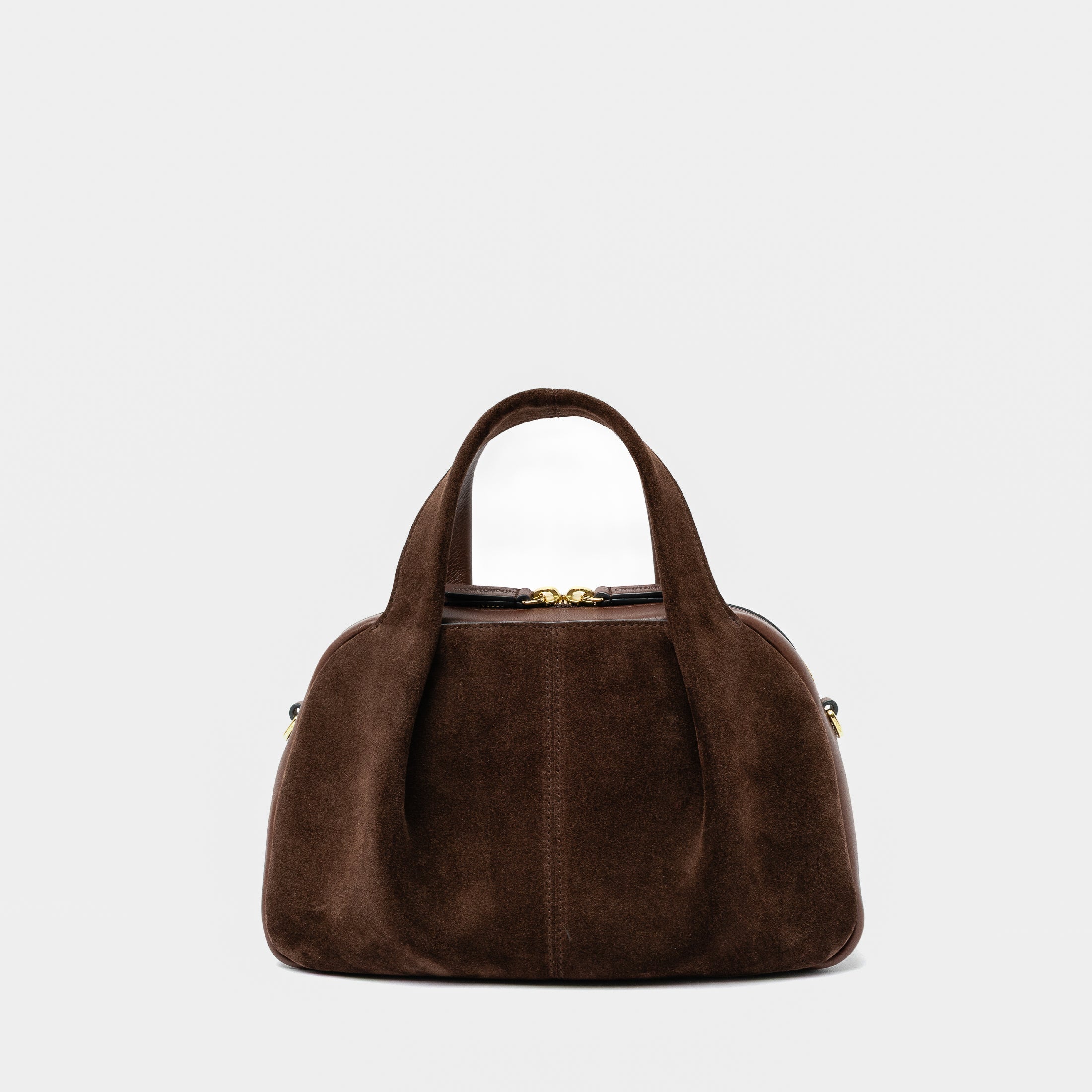 STOW London's Mini Bowling bag in Chocolate suede and smooth leather featuring a pleated front panel and gold-coated stainless steel hardware on a light grey background