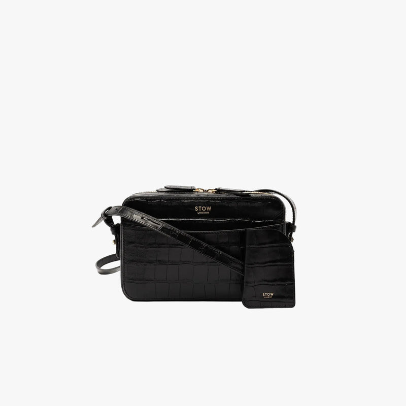 STOW London's Mini Cardholder in Black Embossed Croc leather with the matching Camera Bag on a light grey background featuring a small gold embossed logo on the front bottom