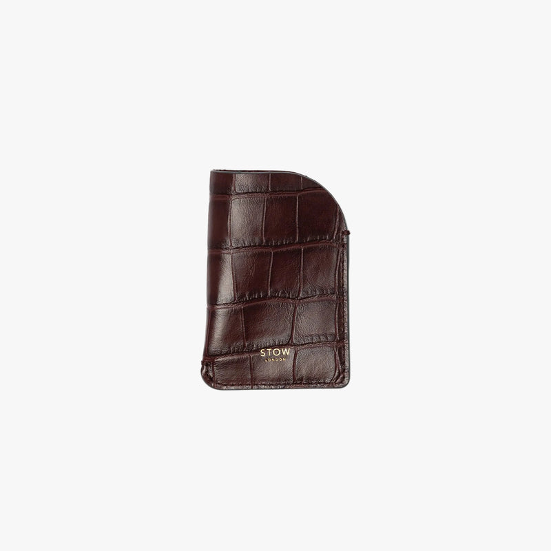STOW London's Mini Cardholder in Burgundy Embossed Croc leather on a light grey background featuring a small gold embossed logo on the front bottom