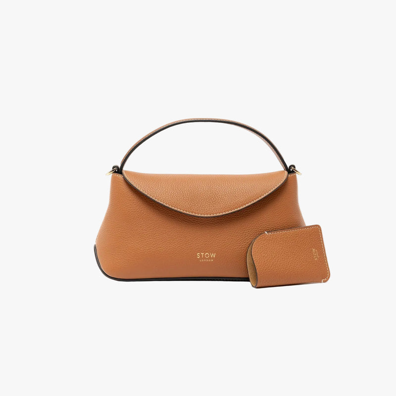 STOW London's Mini Cardholder in Earth Tan pebbled leather and matching Mini East West bag on a light grey background featuring a small gold embossed logo on the front bottom