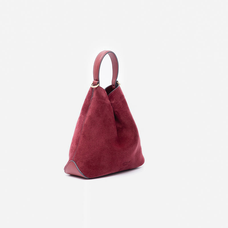 Off-axis view of Stow London's Mini Curve in Burgundy suede leather on a light grey background 