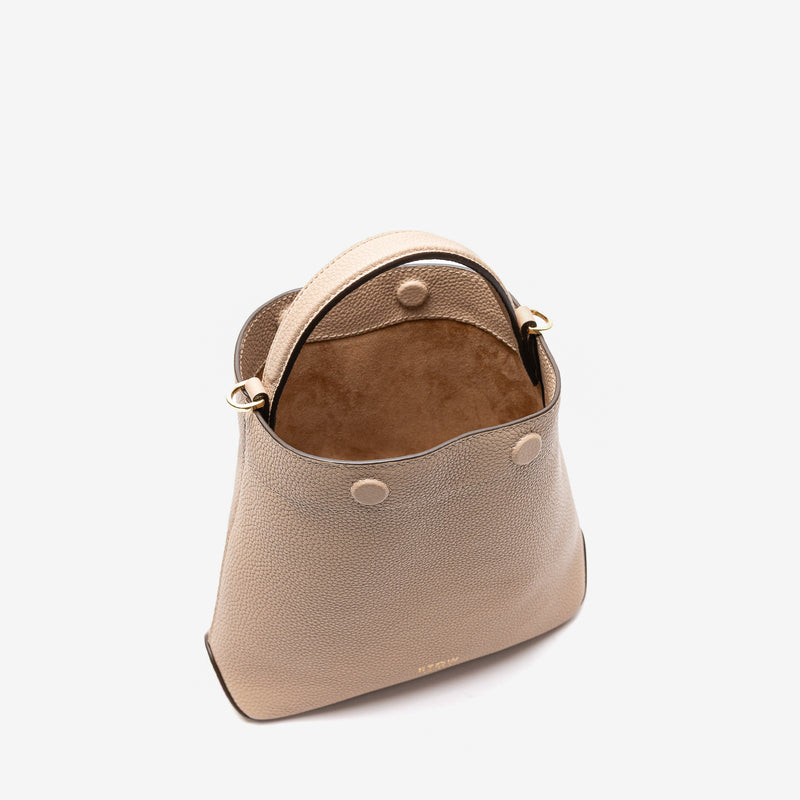 Stow London's Mini Curve in Camel pebbled leather with magnets open styled as a bucket bag, showing the suede interior lining on a light grey background 