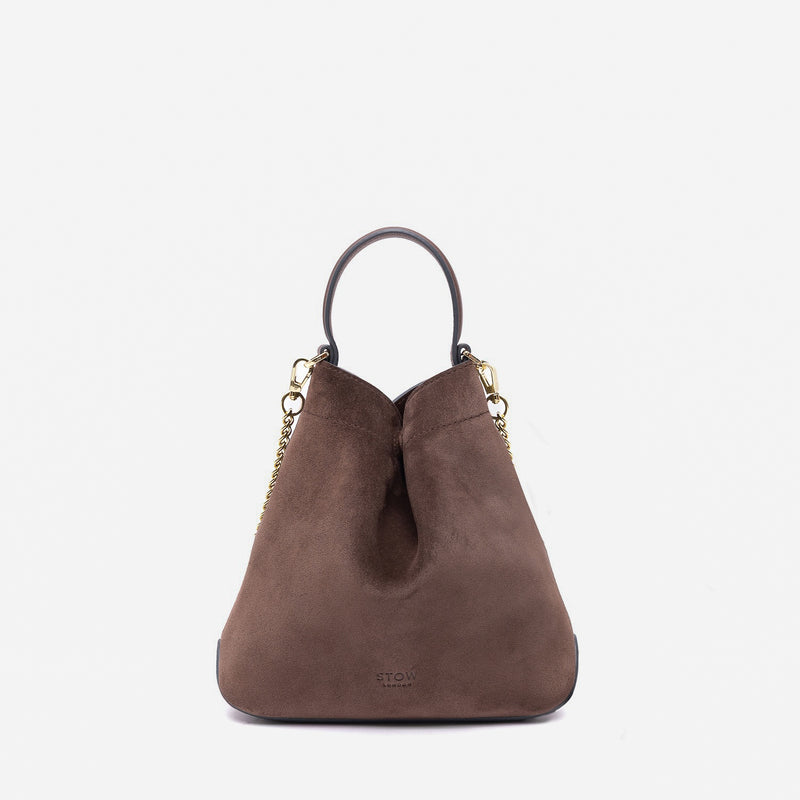 Stow London's Mini Curve in Chocolate suede leather and detachable gold chain crossbody strap on a light grey background 
