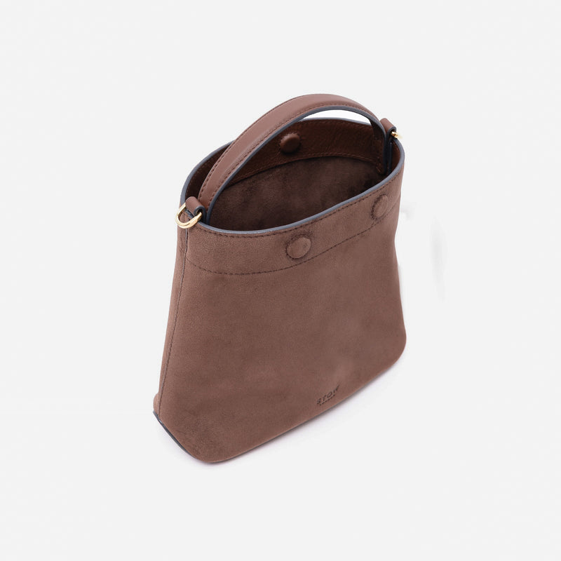 Off-axis view of Stow London's Mini Curve in Chocolate suede leather with magnets open showing suede interior lining on a light grey background 