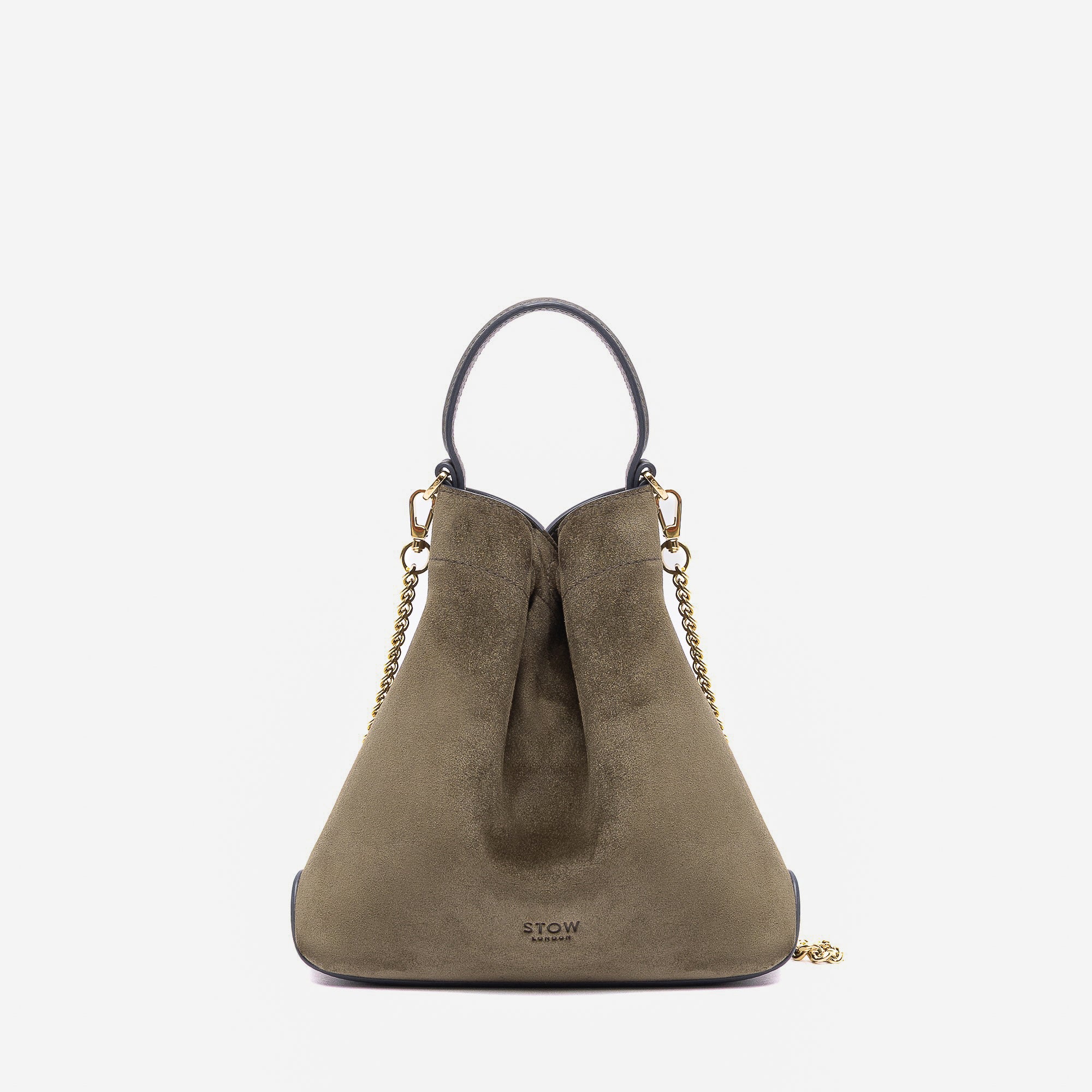Stow London's Mini Curve in Dark Green suede leather featuring gold-coated stainless steel hardware on a light grey background 