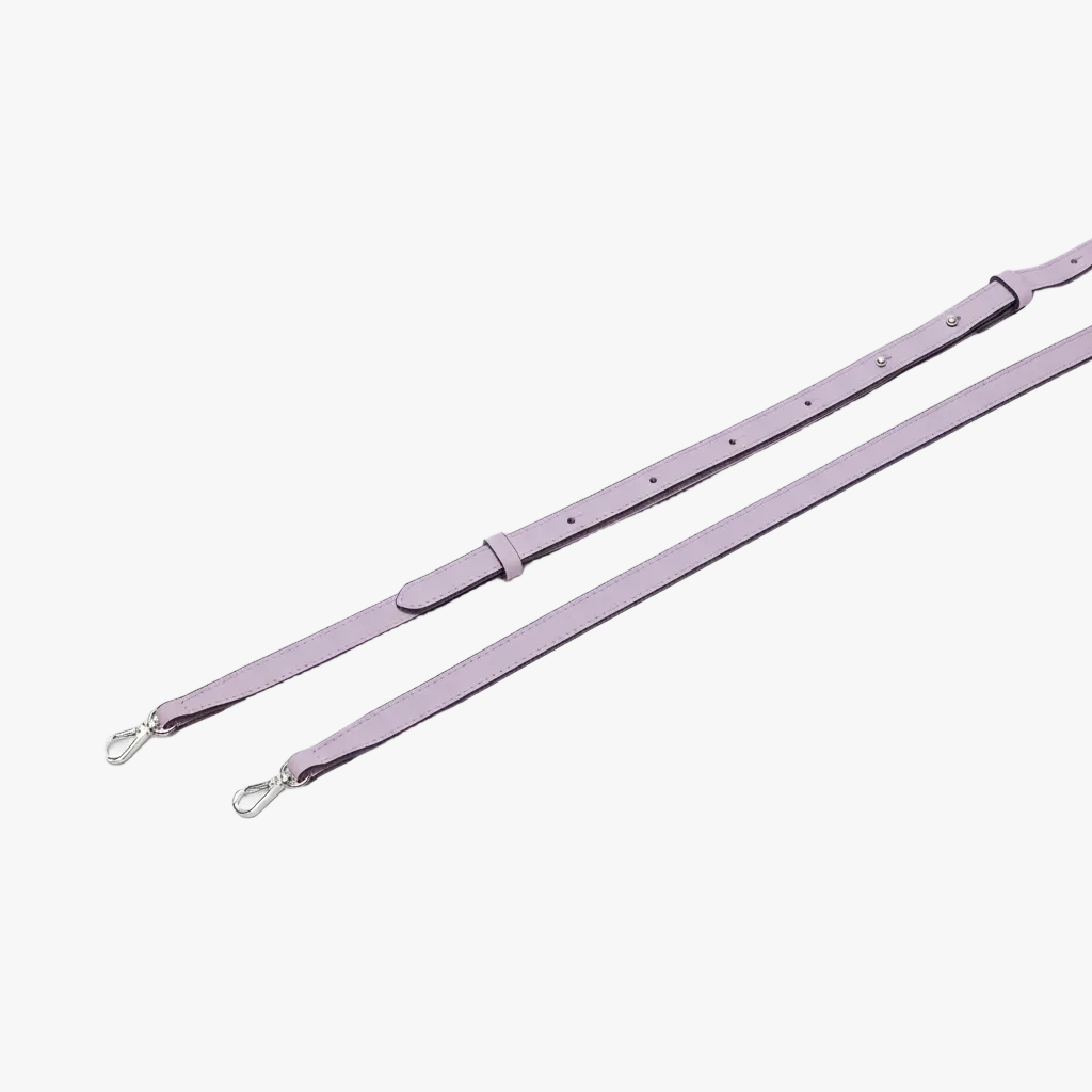 STOW London's Mini Curve crossbody strap in Wild Lavender pebbled leather on a light grey background