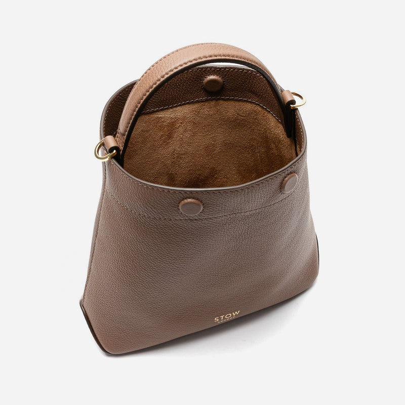 Stow London's Mini Curve in Mocha pebbled leather with magnets open showing suede interior lining on a light grey background 
