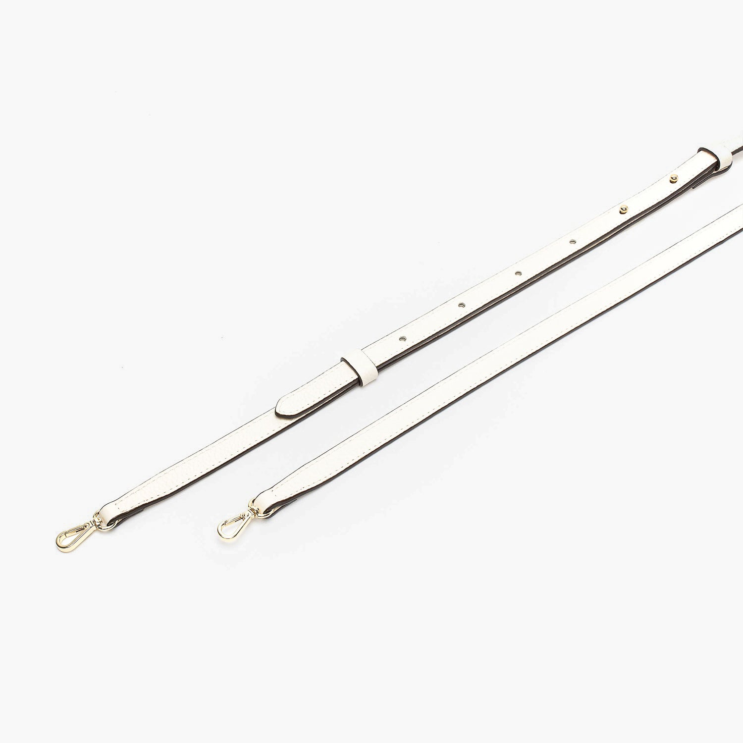 Close up of the detachable leather crossbody strap for STOW London's Mini Curve in Spring Moon pebbled leather on a light grey background 