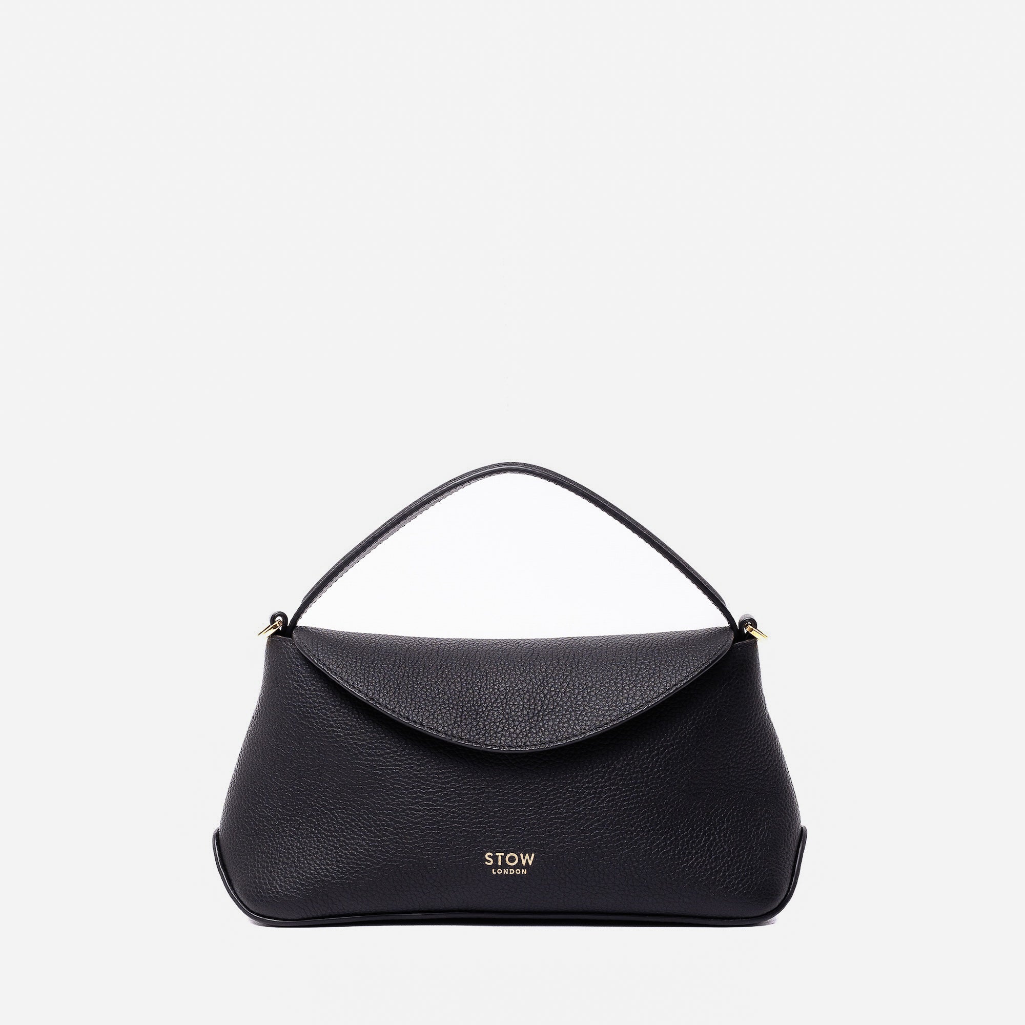 STOW London's Mini East West in Black pebbled leather featuring gold-coated stainless steel hardware on a light grey background