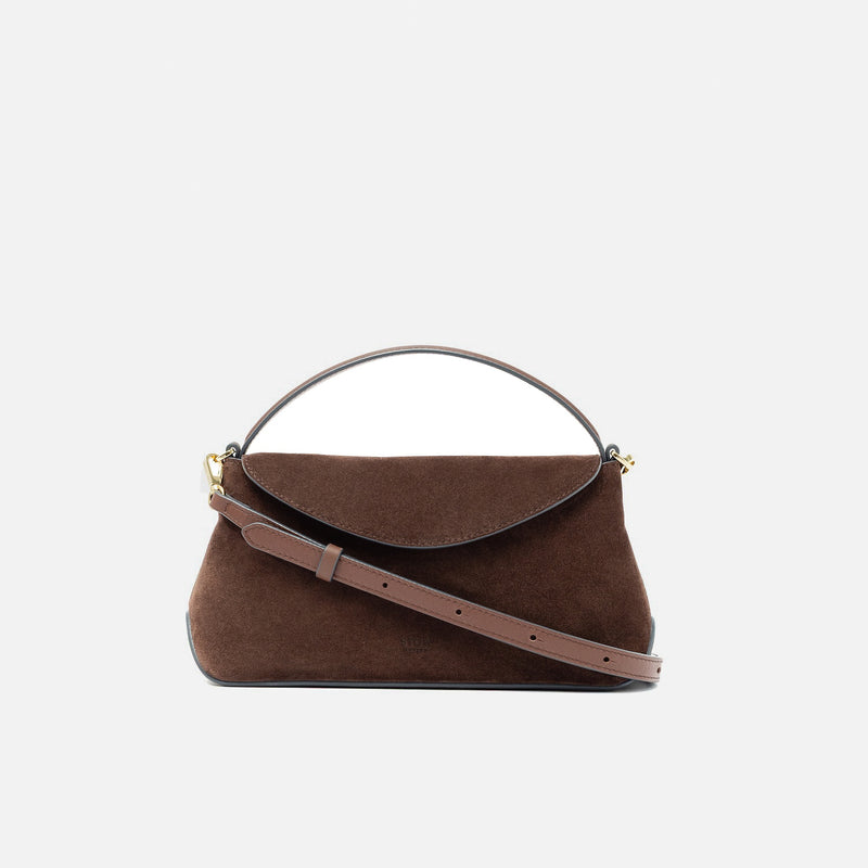 STOW London's Mini East West in Chocolate suede leather and detachable crossbody strap featuring gold-coated stainless steel hardware on a light grey background