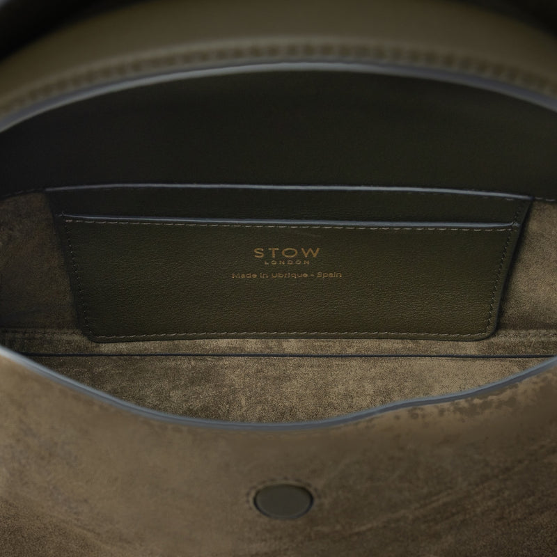 Interior view of STOW London's Mini East West bag in Dark Green Suede leather showing the interior card holder pocket featuring gold details