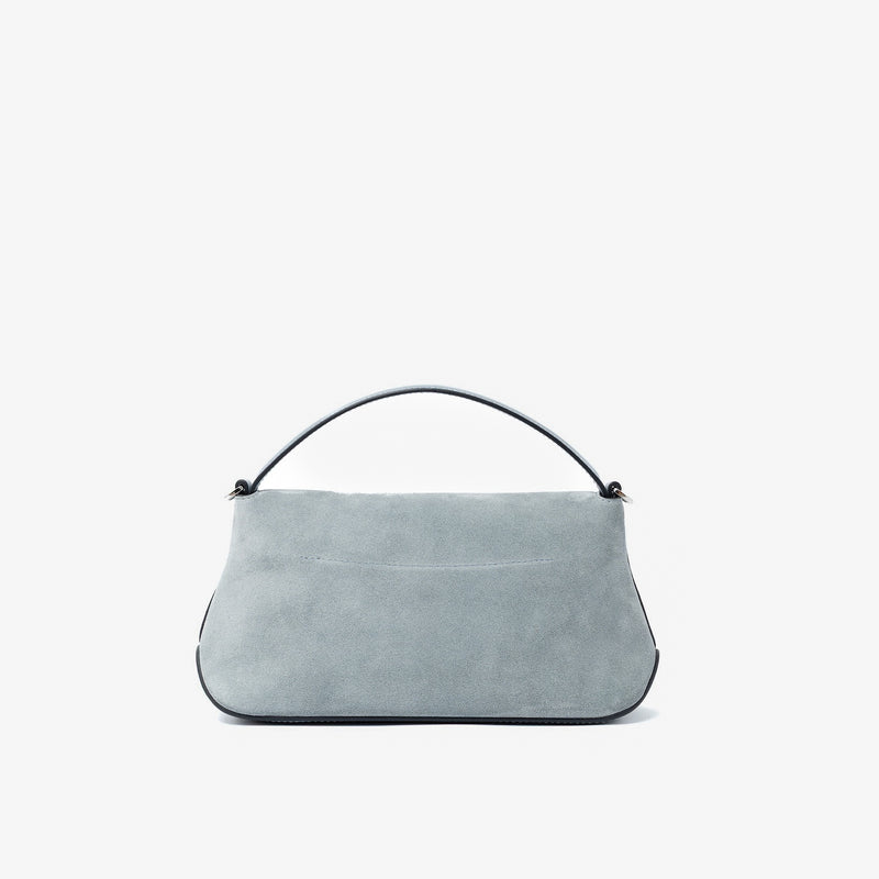 Back panel STOW London's Mini East West in Misty Blue suede leather featuring silver stainless steel hardware on a light grey background