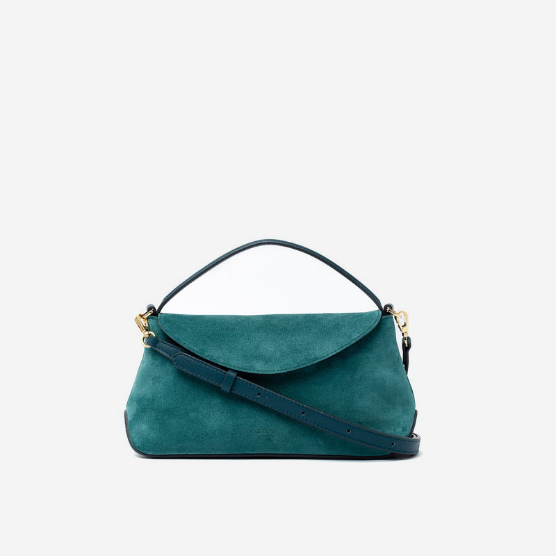 STOW London's Mini East West in Ocean Teal suede leather and detachable crossbody strap featuring gold-coated stainless steel hardware on a light grey background