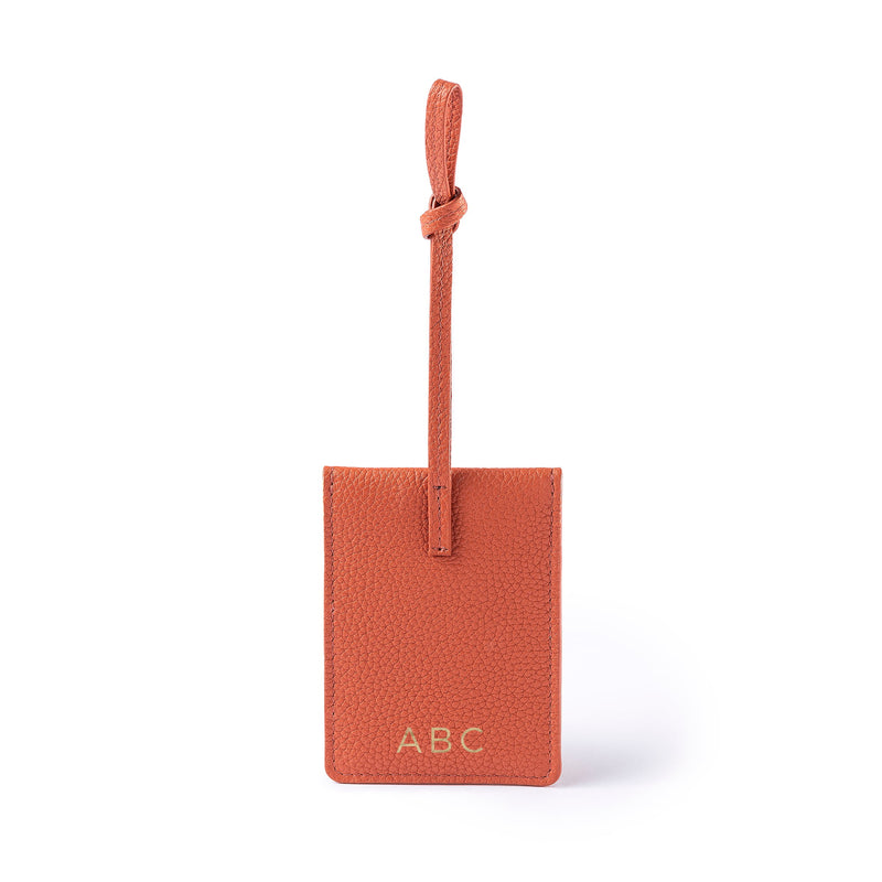 STOW Leather Multi Tag in Clay Orange pebbled leather with personalised initials on the back.