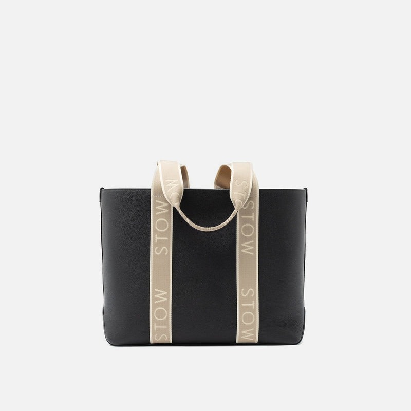 STOW London's Nastro Tote bag in Black pebbled leather with beige nastro handles featuring 'STOW' branding on a light grey background