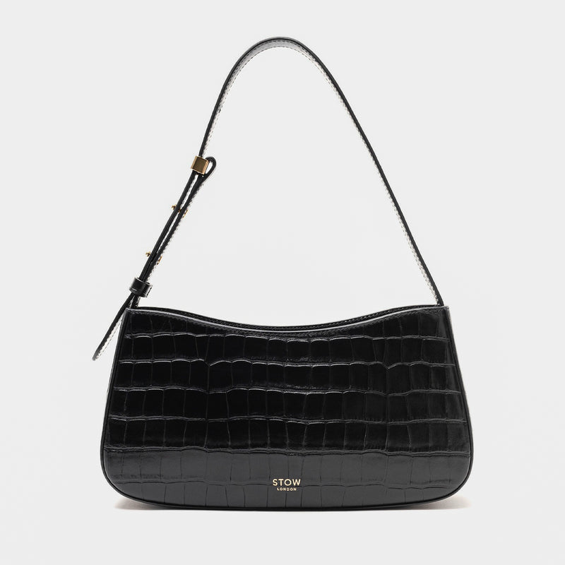 Stow London's Post Shoulder in Black Embossed Croc leather on a light grey background featuring gold-coated stainless steel hardware