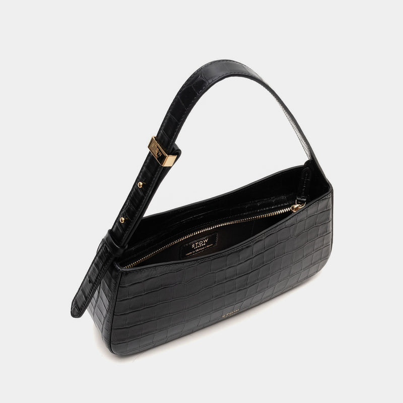 Stow London's Post Shoulder in Black Embossed Croc leather with zip open showing black cotton interior and slip pocket on a light grey background featuring gold-coated stainless steel hardware