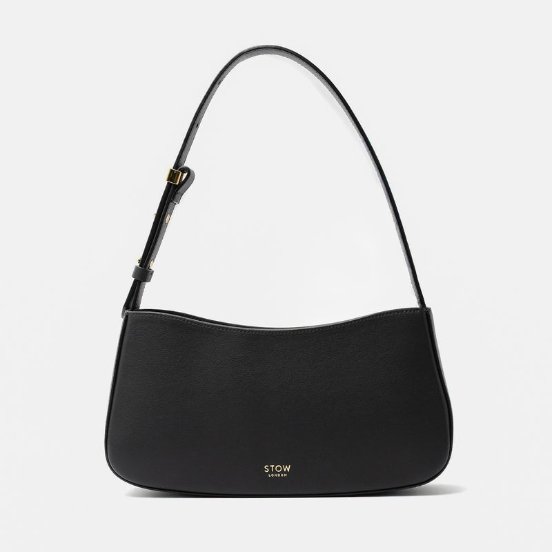 Stow London's Post Shoulder in Black smooth leather on a light grey background featuring gold STOW logo
