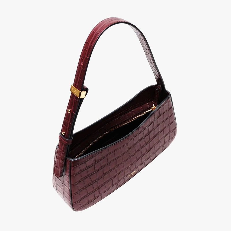 Top view of Stow London's Post Shoulder in Burgundy Embossed Croc leather with zip open showing black cotton interior on a light grey background featuring gold-coated stainless steel hardware