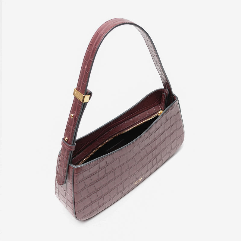 Top view of Stow London's Post Shoulder in Burgundy Embossed Croc leather with zip open showing black cotton interior on a light grey background featuring gold-coated stainless steel hardware