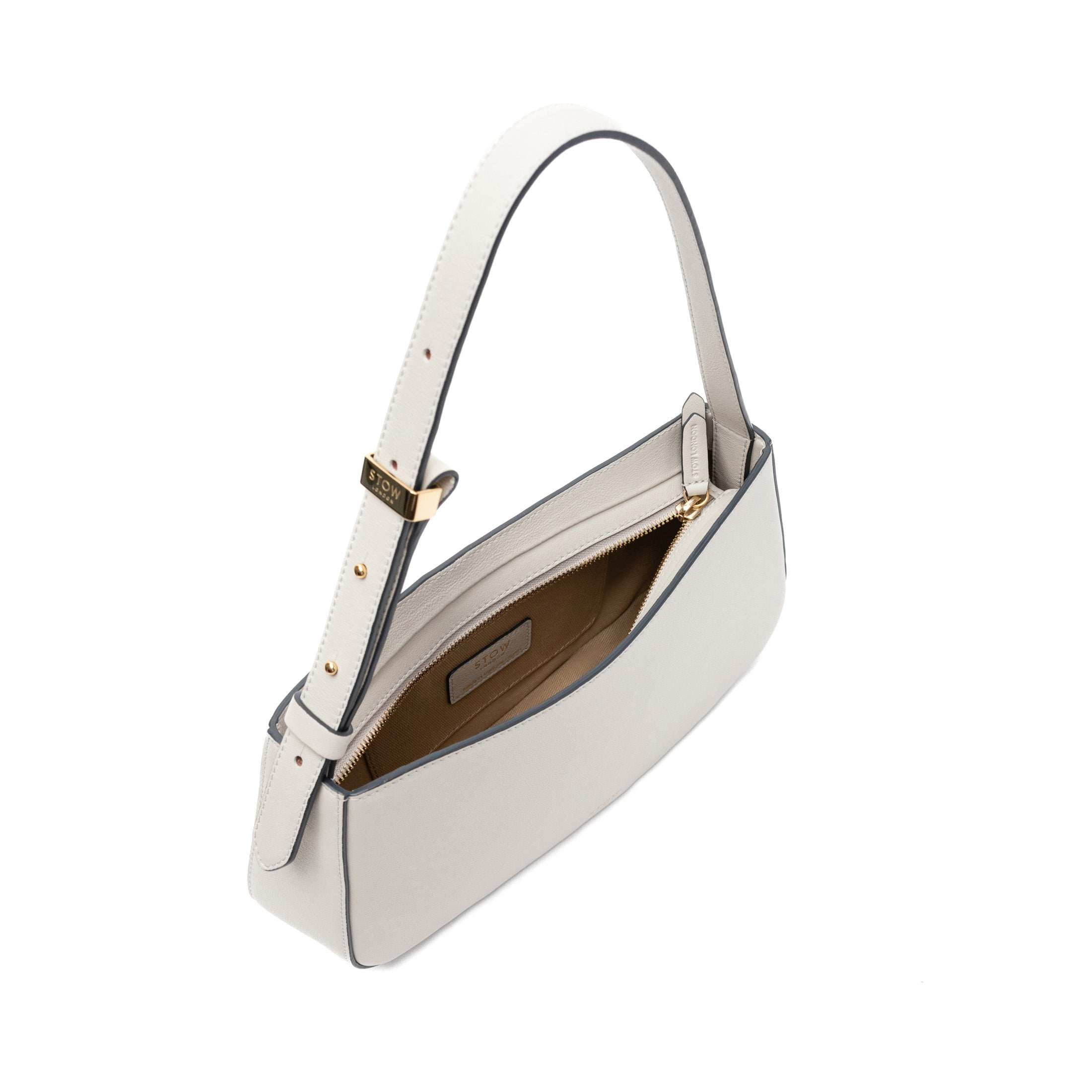 Top view of STOW London's Post Shoulder bag in Cloud Grey smooth leather with zip open showing the bag's interior featuring gold-coated stainless steel hardware on a white background