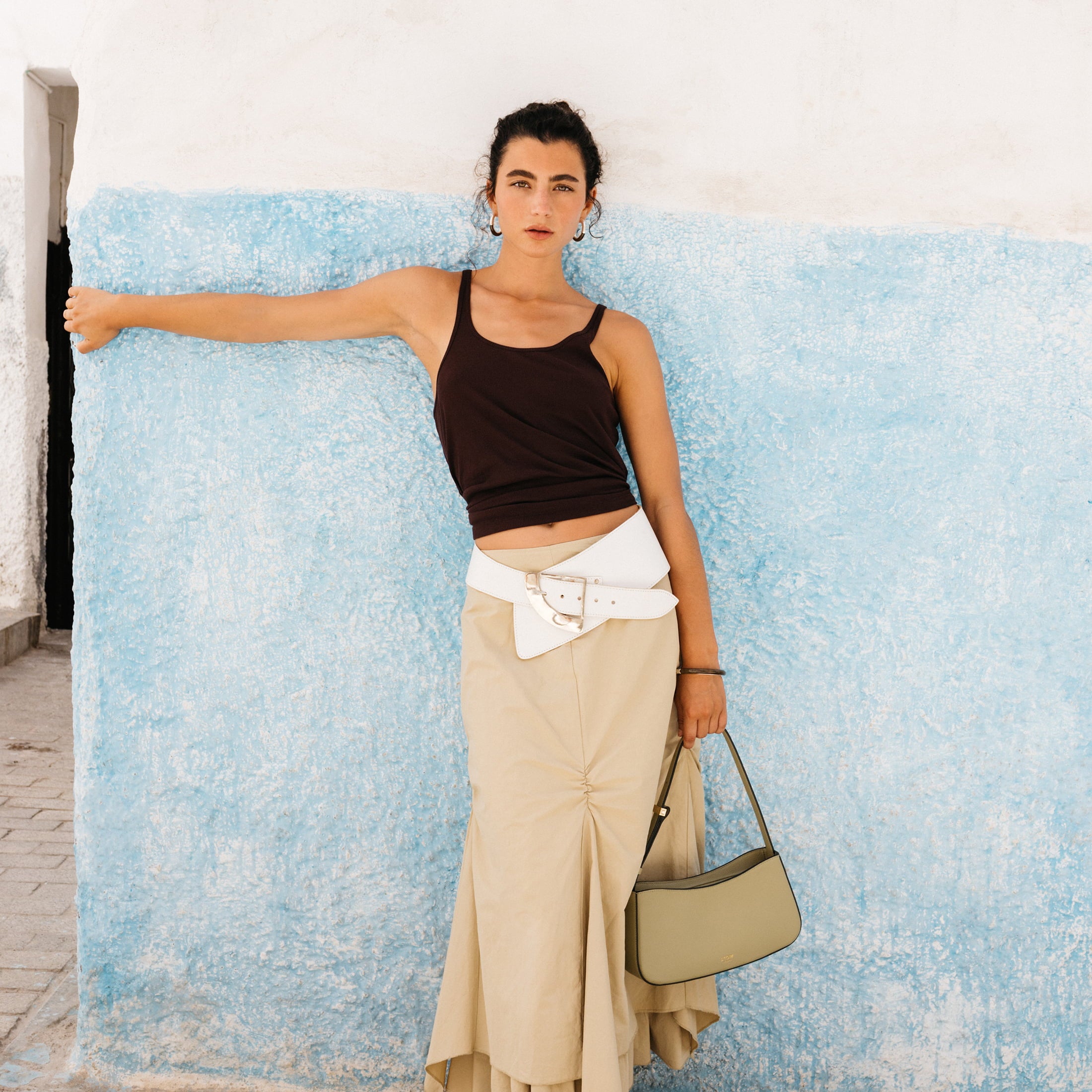 STOW London Post Shoulder Bag in Pale Green leather being worn by model in Tangiers