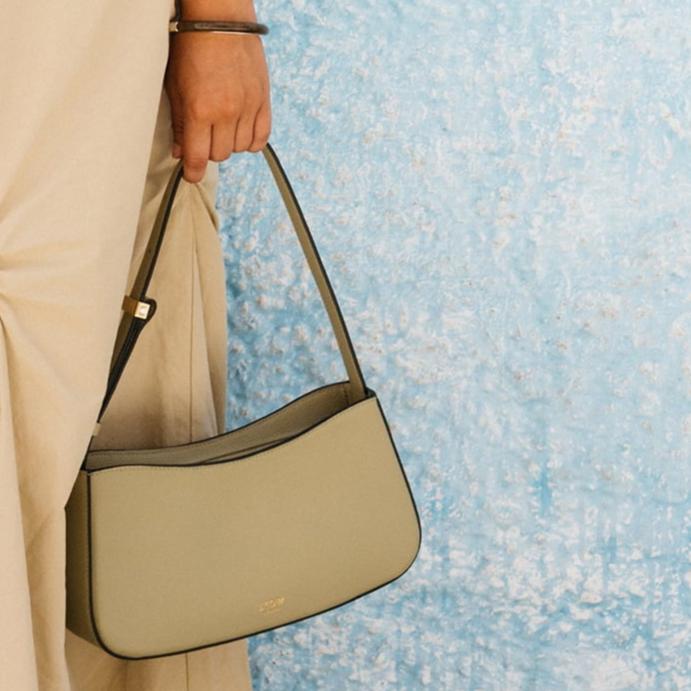 STOW London Post Shoulder Bag in Pale Green leather being worn by model in Tangiers