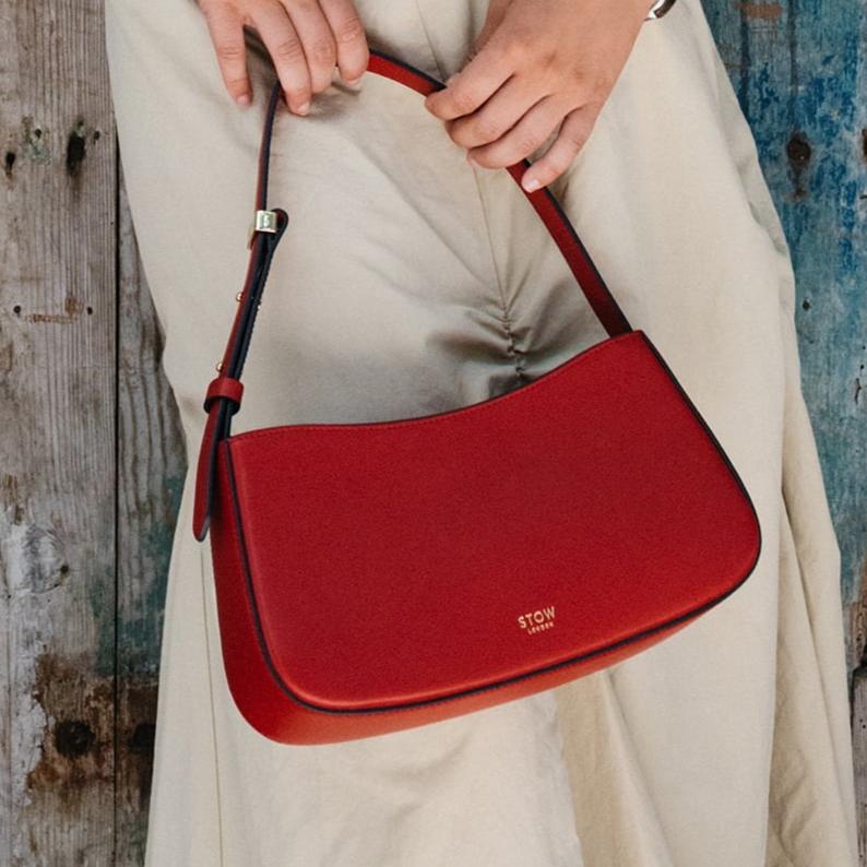 STOW London Post Shoulder Bag in Red leather being worn by model in Tangiers